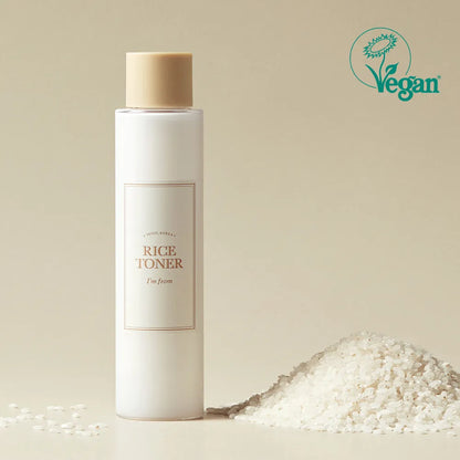 I'm from Rice Toner bottle with a beige cap on a beige background, featuring a Vegan logo.