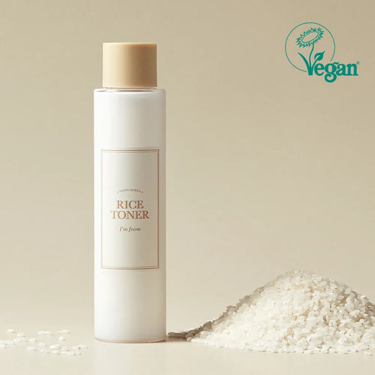 I'm from Rice Toner bottle with a beige cap on a beige background, featuring a Vegan logo.