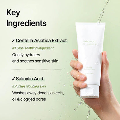 Hand holding a skincare product with key ingredients Centella Asiatica Extract and Salicylic acid listed on a light green background